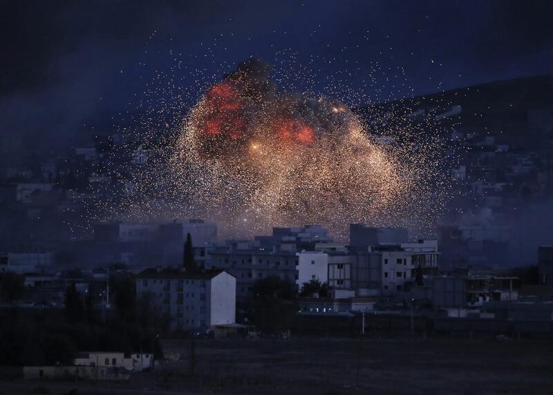 Thick smoke rises from an airstrike by the US-led coalition rise in Kobani, Syria. The GCC states set aside their divergent world views, at least temporarily, to focus on fighting against ISIL. Lefteris Pitarakis/AP Photo