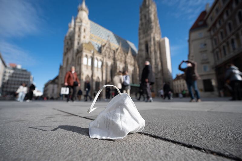 A face mask lies on a street in Vienna as the Austrian Federal Council debates mandatory Covid-19 vaccinations for people over 18. EPA