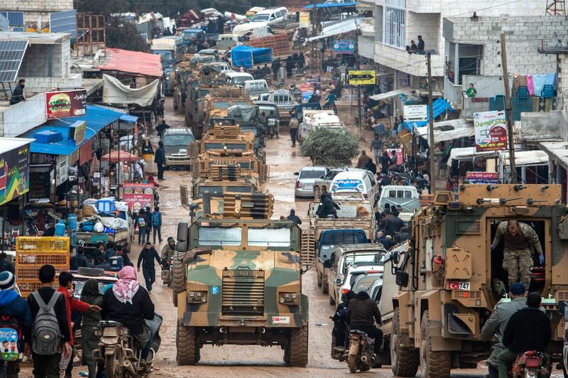 IDLIB, SYRIA - FEBRUARY 22: Turkish Military's armoured vehicles that crossed to Syria drive pass in a road in village of Aaqrabate on February 22, 2020 in Idlib, Syria. Turkey‚Äôs President Recep Tayyip Erdogan in a speech Tuesday threatened, ‚Äúimminent operations in Syria‚Äôs Idlib if Damascus fails to withdraw behind Turkish positions‚Äù The threat comes after Syria‚Äôs government and its ally Russia rejected demands to pull back to ceasefire lines agreed upon in the 2018 Sochi accord. More than 900,000 civilians have been displaced by fighting in or around Idlib since December 1. Idlib is the last rebel stronghold of fighters trying to overthrow Syrian President Bashar al-Assad and in the past years has become the last safe haven for civilians displaced by fighting in other areas of Syria, its population has doubled to close to three million people, many of whom are now fleeing the government offensive towards overcrowded camps close to the Turkish border amid freezing conditions, creating a humanitarian disaster. (Photo by Burak Kara/Getty Images)