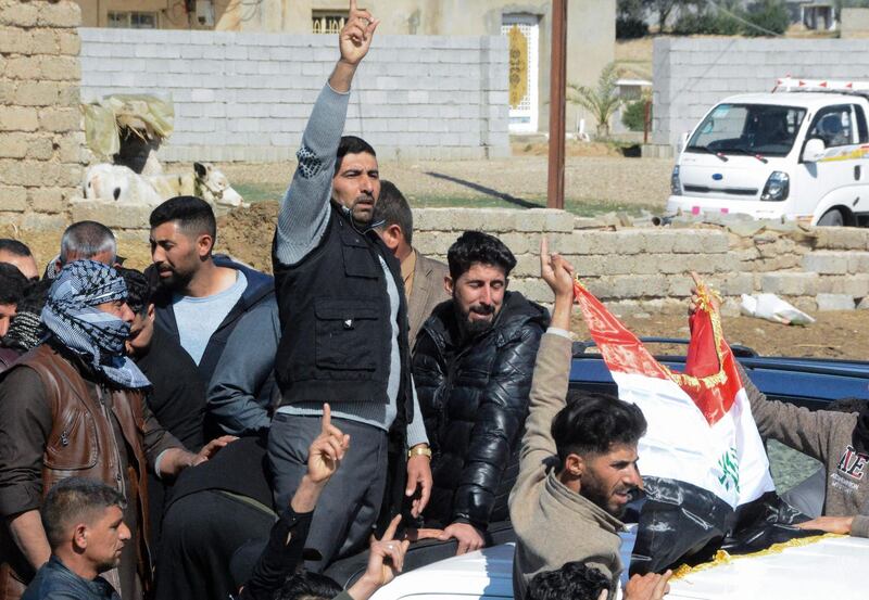 Iraqi mourners pray at the funeral of eight people killed in attacks claimed by ISIS. AFP