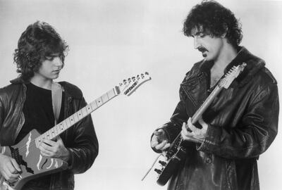 circa 1985:  Promotional studio image of American rock guitarist and composer Frank Zappa (1940 - 1993) playing the electric guitar with his son Dweezil Zappa, early.  (Photo by Hulton Archive/Getty Images)