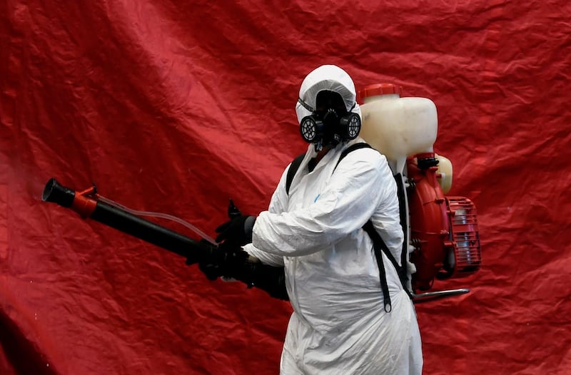 A cleaning worker wearing personal protective equipment disinfects Jamaica Market in Mexico City during the coronavirus pandemic. AFP