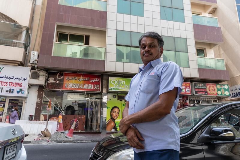 RTA bus driver Naseer Muhammed rushed out of his home to hold out a bedsheet to help save the cat, which fell from the second storey balcony. Here, he poses in front of the building from which the cat fell. Antonie Robertson / The National