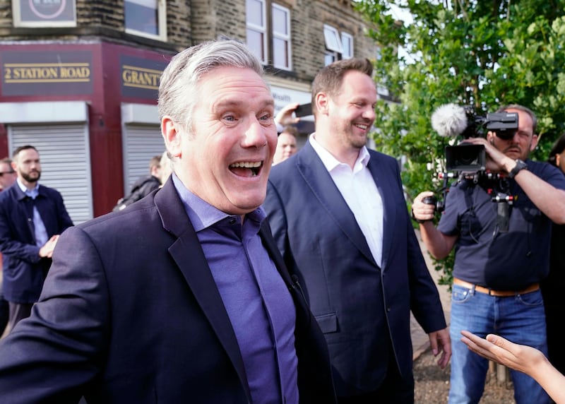 Labour leader Keir Starmer, left, arrives with newly-elected MP for Wakefield Simon Lightwood, as Labour reclaimed the West Yorkshire seat from the Conservatives in Wakefield. AP