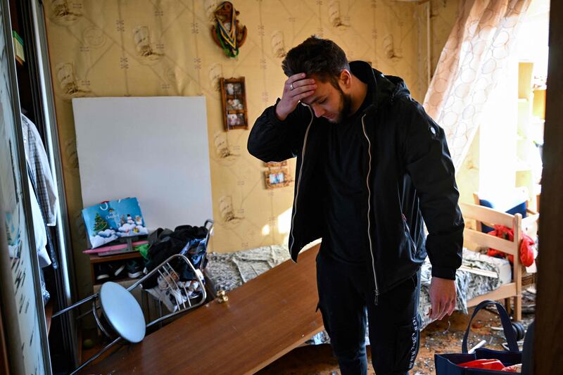 A man feels the despair as his home was hit by debris from a downed rocket in Kyiv. Russian troops trying to encircle the capital have launched early morning strikes on the city for several successive days. AFP