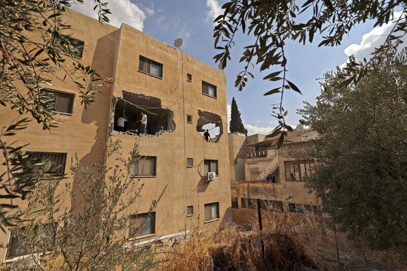 People inspect the flat of Raad Hazem in September. Hazem killed three people in a gun attack in central Tel Aviv in April. His brother, Abed, died in Wednesday's Israeli raid. AFP