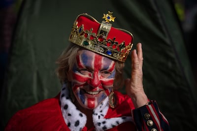 A royal fan adjusts her fake crown as she waits on The Mall. Getty Images