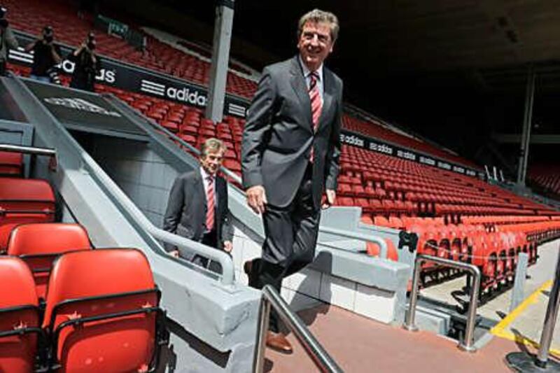 Roy Hodgson, centre, Liverpool's new manager, arrives at Anfield with Martin Broughton, the club's chairman, yesterday.