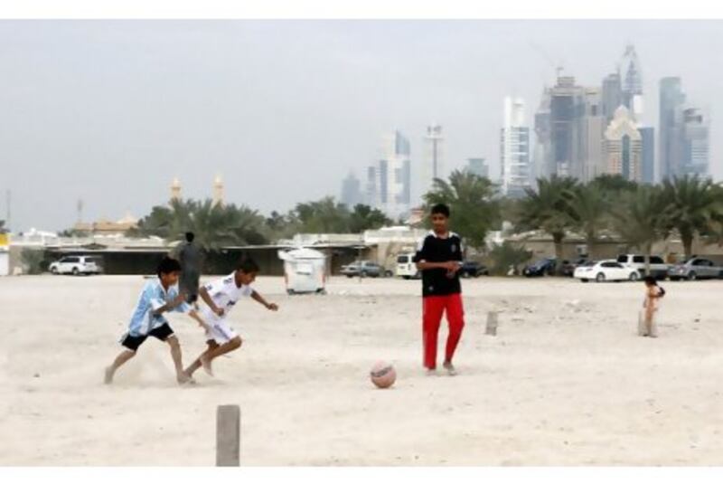 Youngsters playing their favourite sports game the football, at the police housing area on Al Wasl.