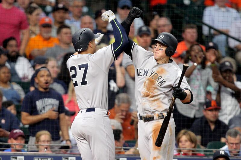 New York Yankees Giancarlo Stanton, left, celebrates his home run against the Houston Astros with teammate Tyler Austin. Erik Williams / USA TODAY Sports