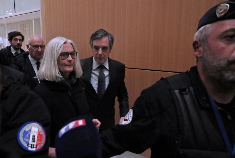 epa08243625 Former French Prime Minister Francois Fillon (C) and his wife Penelope (L) arrive at the courthouse in Paris, France, 24 February 2020. The ex-prime minister is accused of employing his wife as a highly-paid aide for years despite the lack of evidence that she performed any legitimate work.  EPA/CHRISTOPHE PETIT TESSON