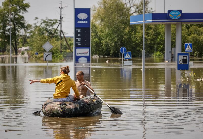 Residents on a flooded street in Kherson. Reuters