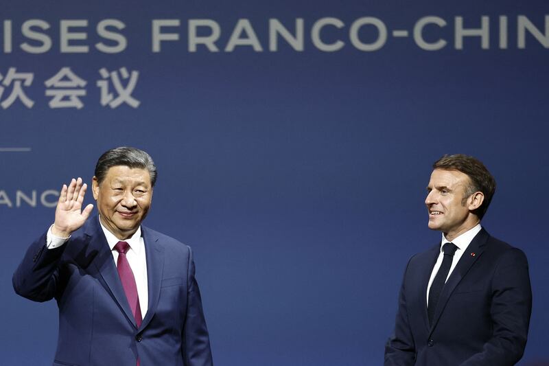 Mr Xi and Mr Macron at the Franco-Chinese Business Council event. AFP