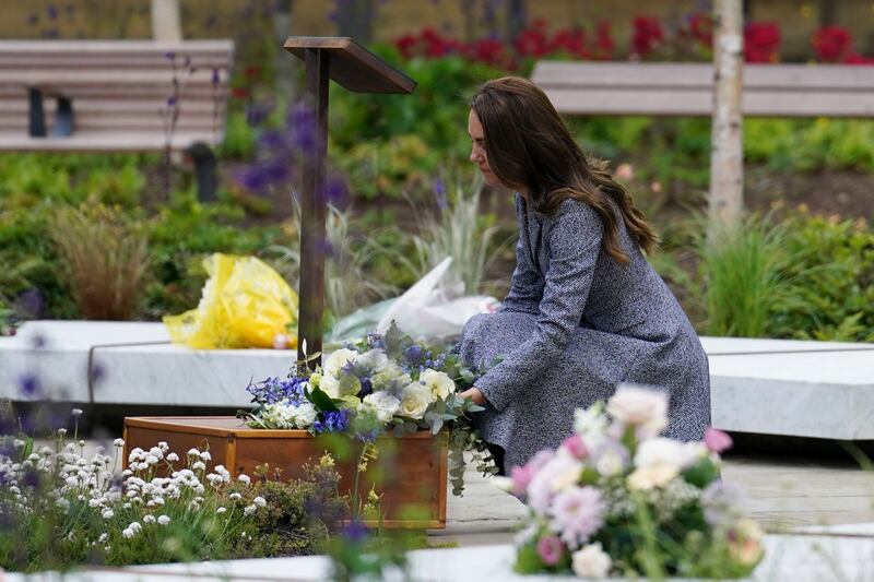 Kate lays flowers at the Glade of Light memorial garden. AP Photo