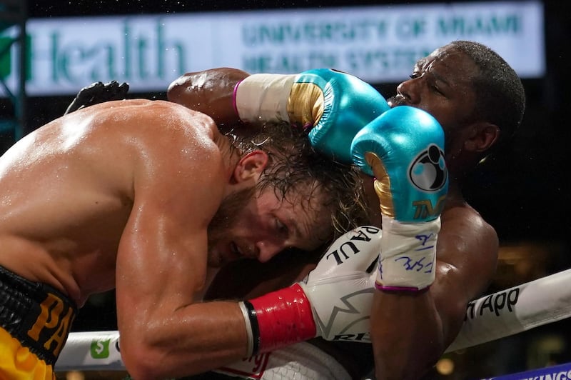 Floyd Mayweather and Logan Paul in action during an exhibition boxing fight at Hard Rock Stadium. Reuters