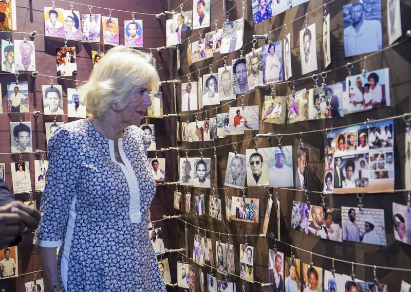 The Duchess of Cornwall looks at pictures of the victims of the genocide at the Kigali Genocide Memorial. PA