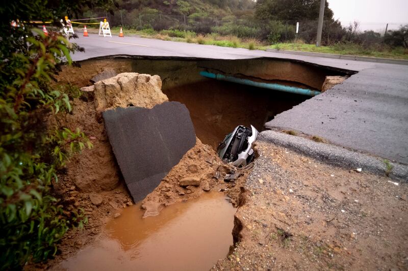 Cars in a sinkhole along Iverson Road in Chatsworth. The Orange County Register / AP