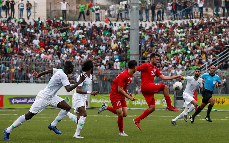 Palestine's midfielder Nazmi Albadawi (3rd-R) intercepts the ball during the World Cup 2022 Asian qualifying match between Palestine and Saudi Arabia in the town of al-Ram in the Israeli occupied West Bank. The game would mark a change in policy for Saudi Arabia, which has previously played matches against Palestine in third countries. Arab clubs and national teams have historically refused to play in the West Bank, where the Palestinian national team plays, as it required them to apply for Israeli entry permits.  AFP