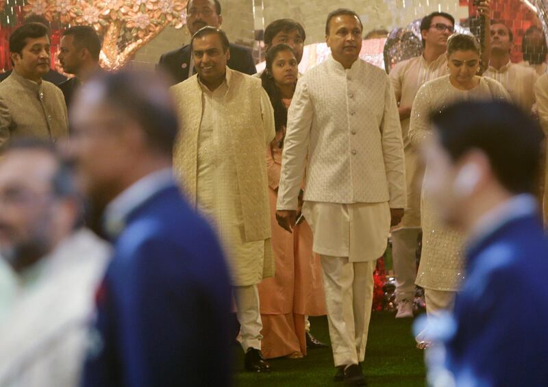 Father of the bride Mukesh Ambani, center left, with his brother Anil Ambani. AP Photo
