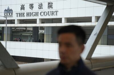 People walk near an entrance of the High Court where a court hearing on property developer China Evergrande Group was being held, in Hong Kong, on January 29, 2024. Reuters