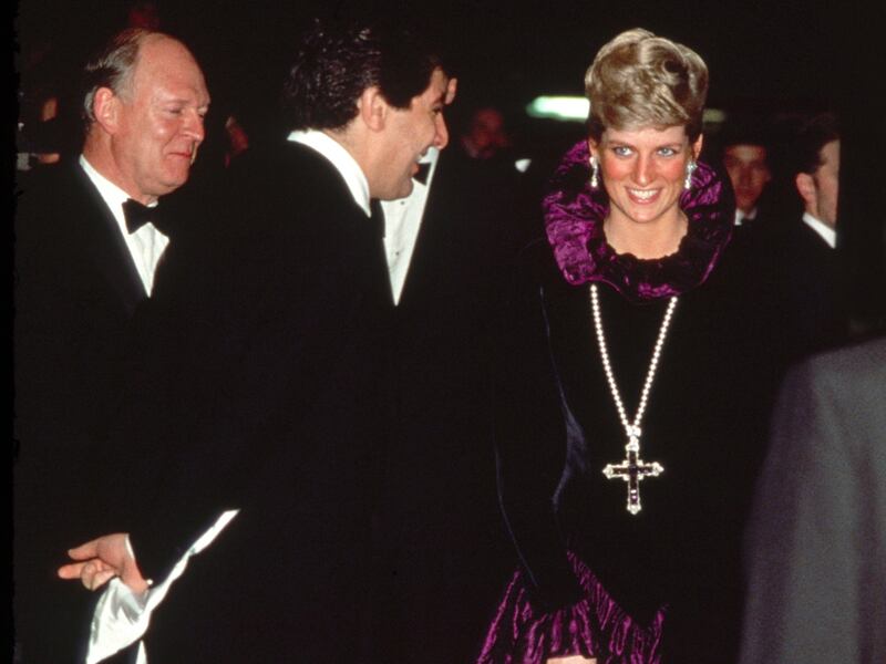 Princess Diana wears the Attallah Cross with an Elizabethan-style Catherine Walker dress at a charity engagement in 1987. Getty Images