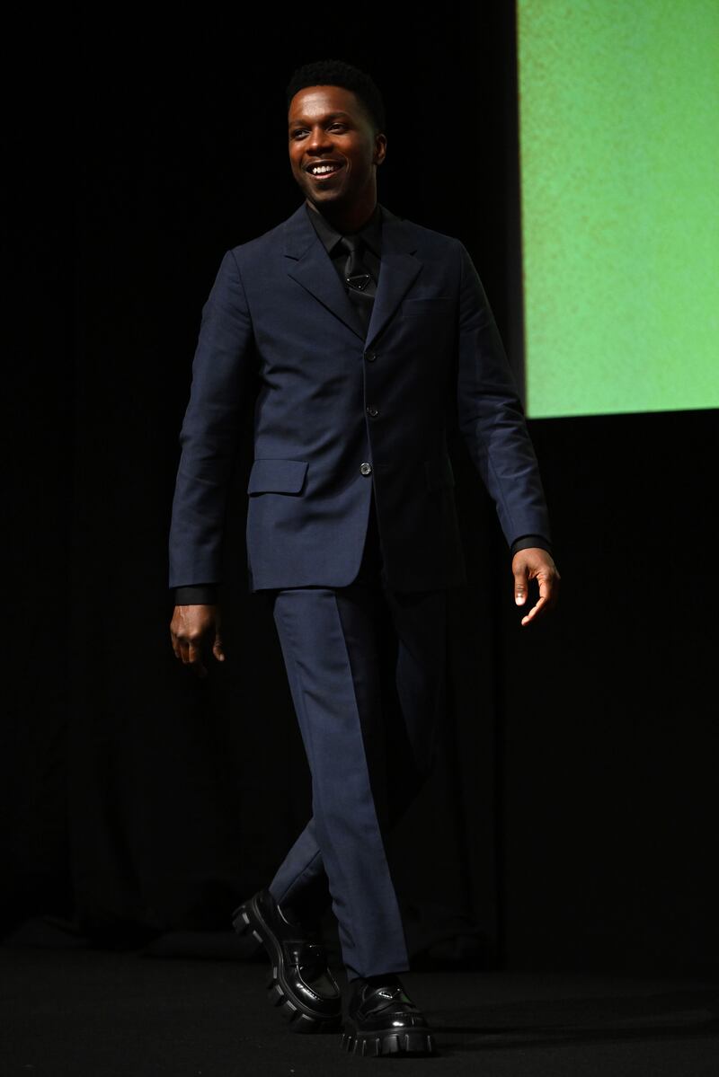 Leslie Odom Jr, wearing Prada, walks out on stage at the 'Glass Onion: A Knives Out Mystery' European premiere. Getty Images 