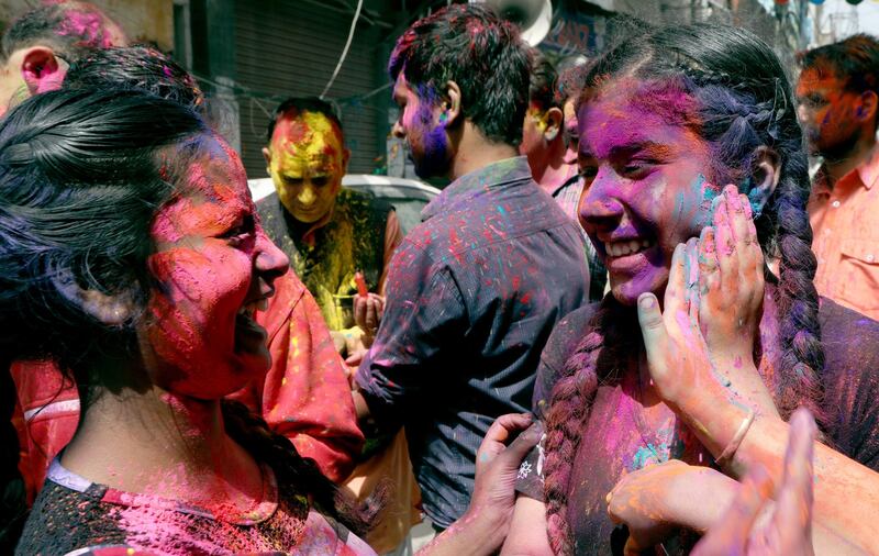 People apply colour on each other during Holi festival celebrations in Jammu, the winter capital of Kashmir, India. EPA