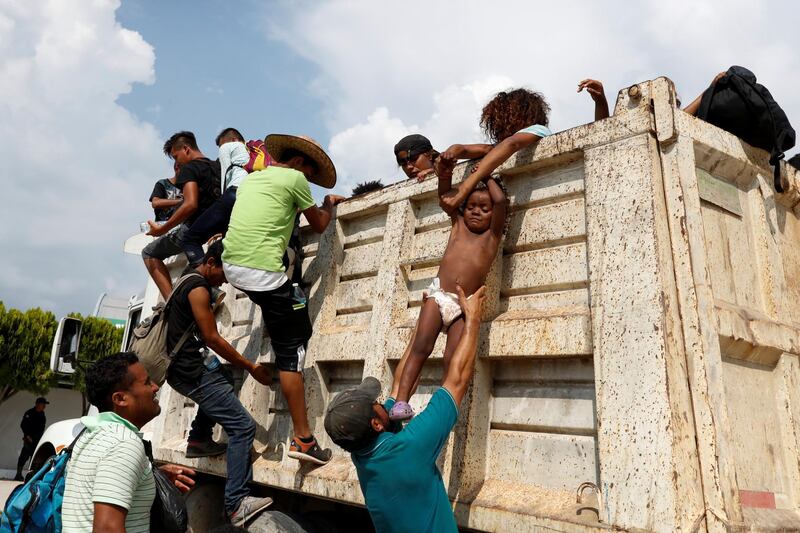 Migrants get off a truck in Arriaga, Mexico. Reuters