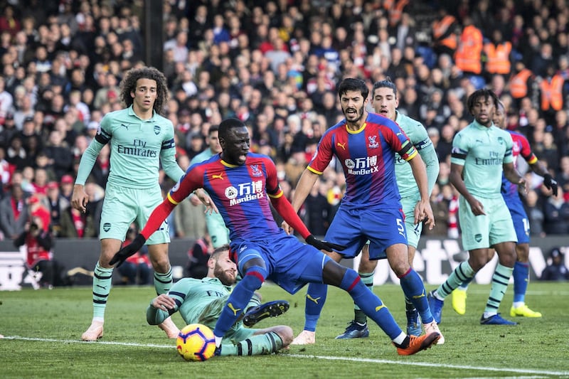 LONDON, ENGLAND - OCTOBER 28: Shkodran Mustafi of Arsenal fouls Cheikhou KouyatÃ© of Crystal Palace giving the 1st penalty for home side during the Premier League match between Crystal Palace and Arsenal FC at Selhurst Park on October 28, 2018 in London, United Kingdom. (Photo by Sebastian Frej/MB Media/Getty Images)