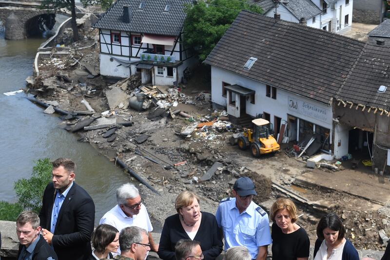 German Chancellor Angela Merkel, centre, visited one of the flood-hit areas on Sunday and described the disaster as terrifying. EPA