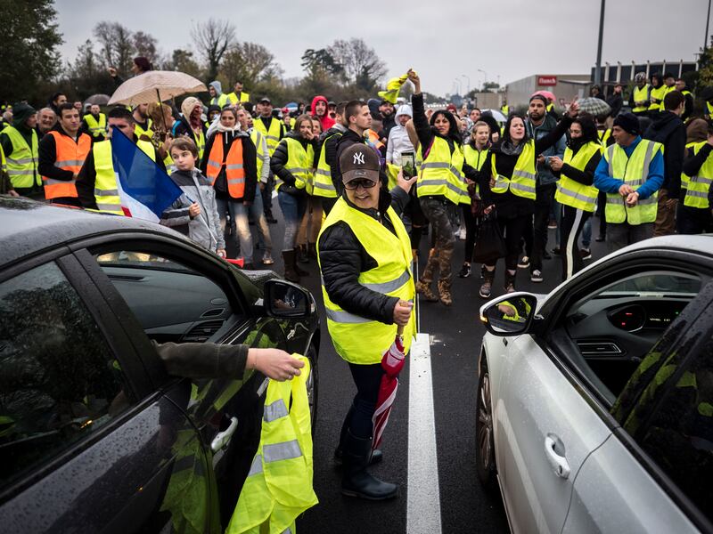 People wear yellow jackets in a protest against rising prices of fuel and oil in November 2018 in Avignon, France.