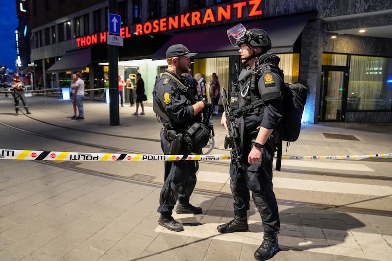 Police officers secure the scene after several shots were fired outside the London pub in the center of Oslo, Norway, 25 June 2022.  Two people were killed and at least 10 were injured after a gunman fired shots outside the London pub, a gay bar and nightclub.   EPA / Javad Parsa  NORWAY OUT