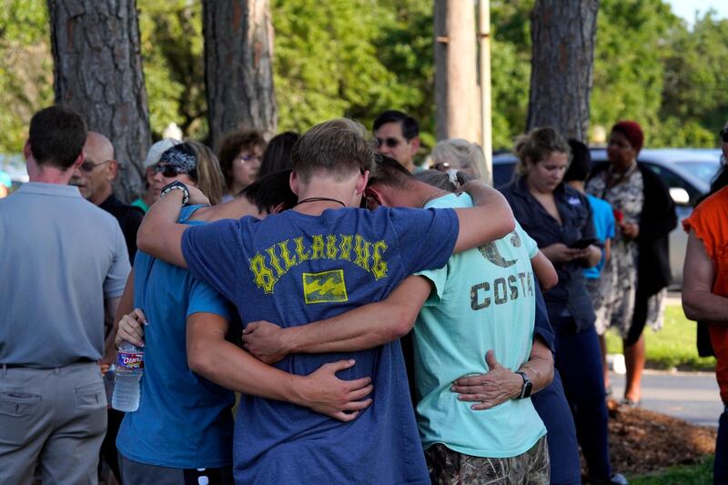 People comfort each other at a vigil set up close to Santa Fe High School where a gunman shot numerous people in Santa Fe, Texas. Matt Patterson / EPA