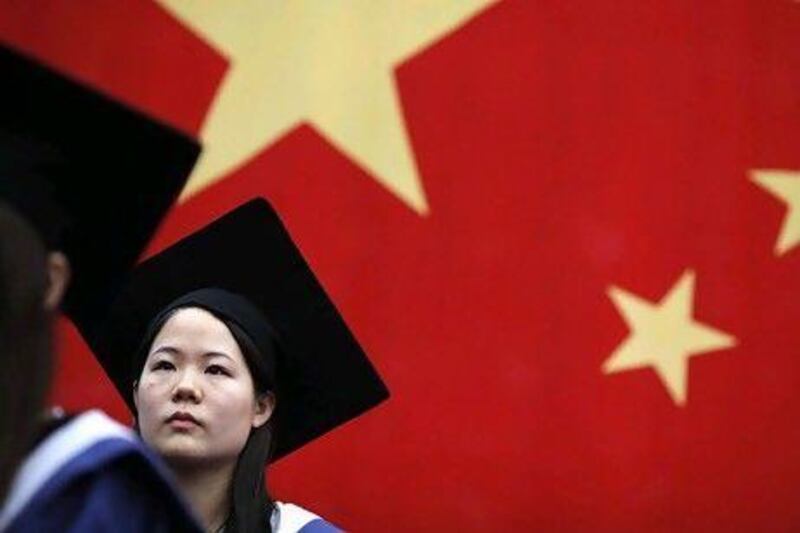 A student at her college graduation ceremony at Fudan University in Shanghai. University education is a key component of China's goal to create a broad urban tier of middle-class families.
