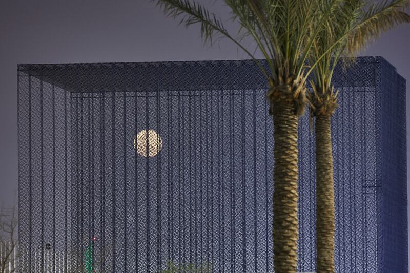 A pink supermoon rises behind the Sustainability Portal. Expo 2020 Dubai was postponed from last year due to the coronavirus pandemic.