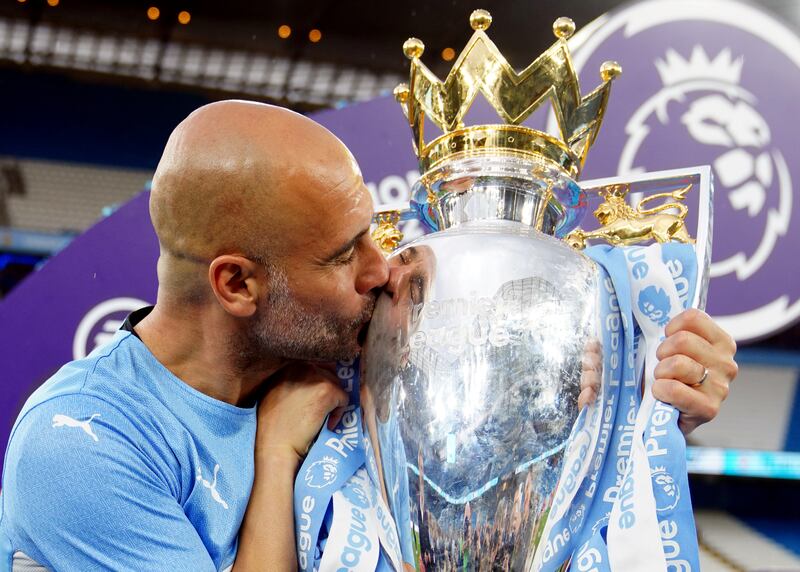 Pep Guardiola with the Premier League trophy after winning the title at the end of the 2021/22 season. AFP