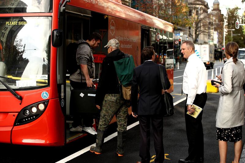 People board a bus as public transport returns to normal in Auckland, New Zealand. Getty Images