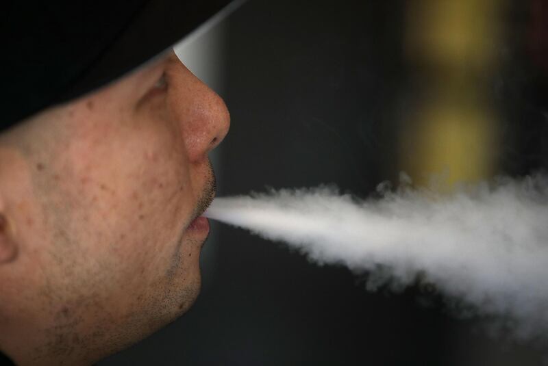(FILES) In this file photo taken on January 22, 2018 shows Jeremy Wong blows vapor from an e-cigarette at The Vaping Buddha on January 23, 2018 in South San Francisco, California.  US health officials are investigating the cases of dozens of people, mainly teens, who were hospitalized with severe lung injuries in recent weeks after vaping, though the precise cause of their illnesses remains a mystery. / AFP / GETTY IMAGES NORTH AMERICA / Justin SULLIVAN
