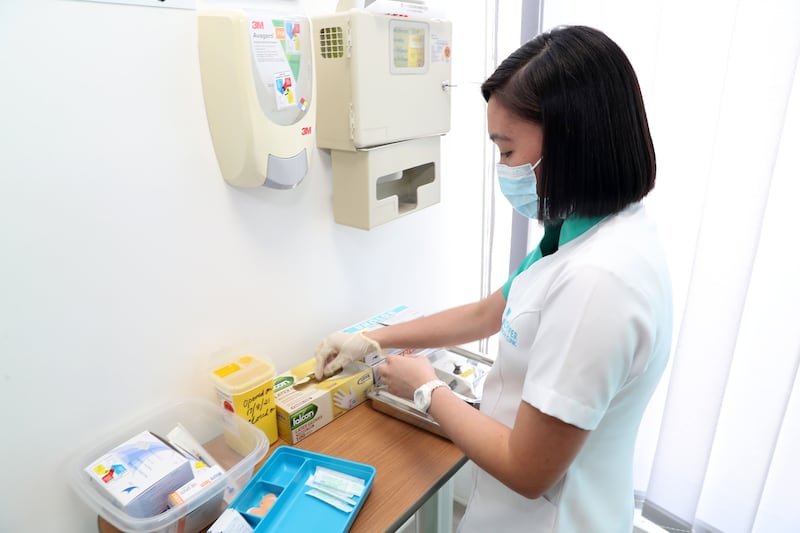 Nurse Dennise Docil prepares before administering the Pfizer Covid-19 vaccine at the NMC Royal Hospital DIP in Dubai.
