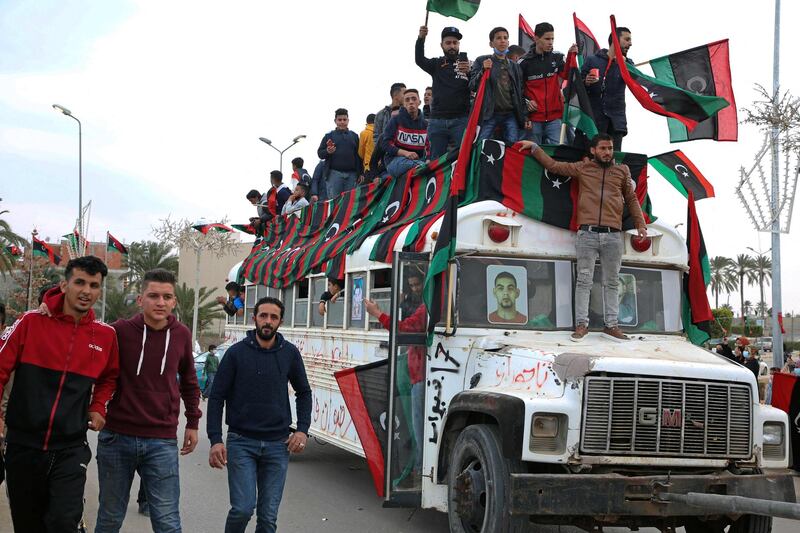 A bus is decorated with flags to celebrate the 2011 uprising in Libya. AFP