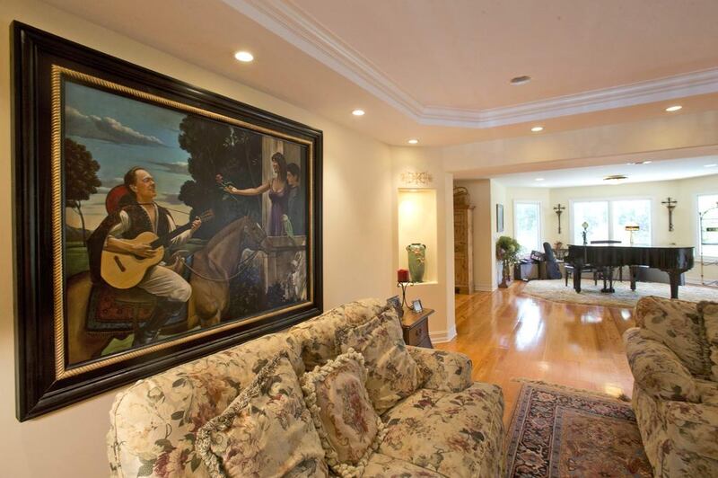 A painting depicting 1970’s heartthrob David Cassidy, left, his son, a parrot and soon-to-be ex-wife hangs in the house. AP