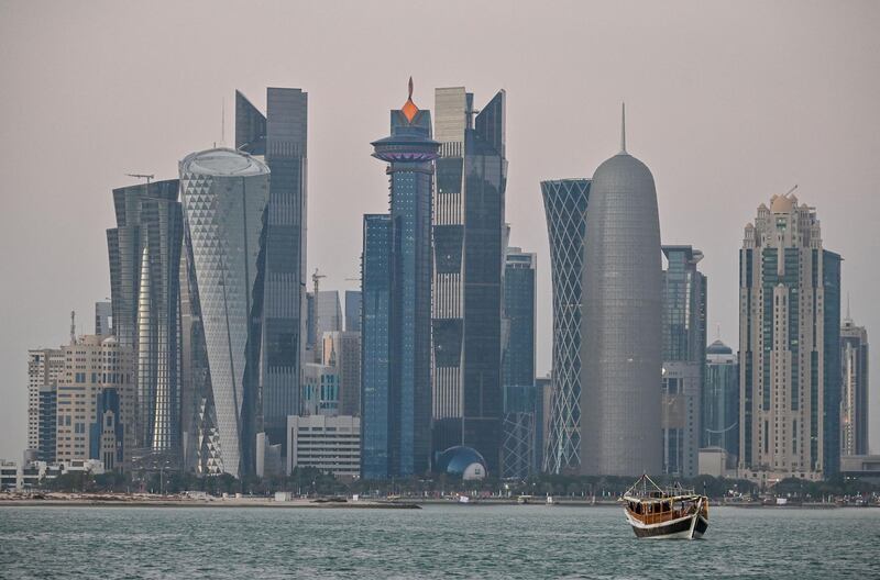 A general view taken on December 20, 2019 shows boats moored in front of the skyline of the Qatari capital, Doha. (Photo by GIUSEPPE CACACE / AFP)