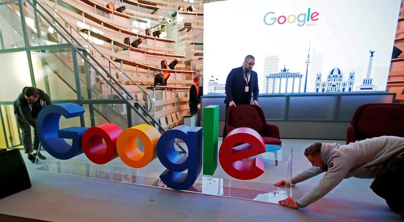 FILE PHOTO: Workers move a Google logo during the opening of the new Alphabet's Google Berlin office in Berlin, Germany, January 22, 2019. REUTERS/Hannibal Hanschke/File Photo