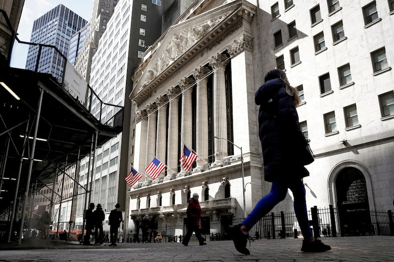 People walk on Wall Street outside the New York Stock Exchange. Weaker economic data is becoming more supportive of stocks and, conversely, dollar negative. Photo: Reuters