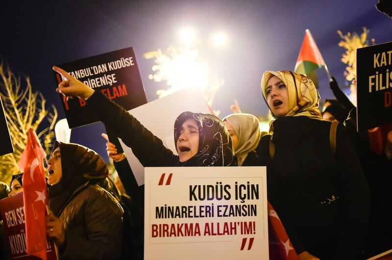 A woman holds a sign during a demonstration against the US and Israel at Fatih Mosque in Istanbul. Yasin Akgul/ AFP Photo
