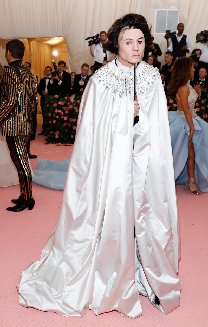 Ezra Miller's outfit was so theatrical it deserves a second mention. Here he arrives at the event in a silver cape and carrying a mask, as if attending a masquerade ball. Reuters