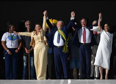 Brazil's new President Luiz Inacio Lula da Silva (C) and new Vice-President Geraldo Alckmin, with their wives First Lady Rosangela da Silva (2-L) and Maria Lucia Ribeiro Alckmin (R) respectively gesture at supporters at Planalto Palace after their inauguration ceremony at the National Congress, in Brasilia, on January 1, 2023.  - Lula da Silva, a 77-year-old leftist who already served as president of Brazil from 2003 to 2010, takes office for the third time with a grand inauguration in Brasilia.  (Photo by CARL DE SOUZA  /  AFP)