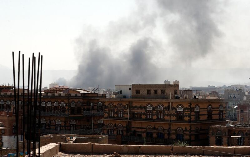 epa09058915 Smoke billows above a neighborhood following Saudi-led airstrikes targeting positions in Sana'a, Yemen, 07 March 2021. The Saudi-led coalition's warplanes waged a series of airstrikes on positions across Yemen, including the capital Sana'a.  EPA/YAHYA ARHAB