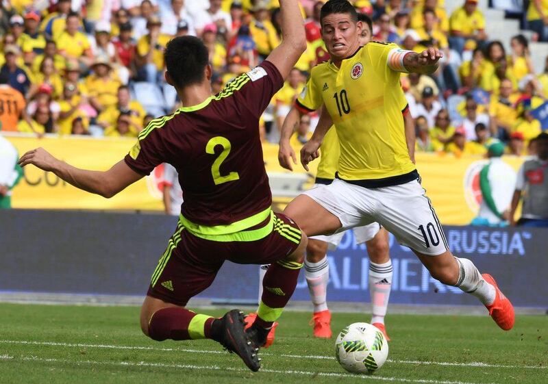 Venezuela's Wilker Angel, left, vies for the ball with Colombia's James Rodriguez during their South America 2018 World Cup qualifier in Barranquilla, Colombia on September 1, 2016. Colombia won the match 2-0. Luis Acosta / AFP