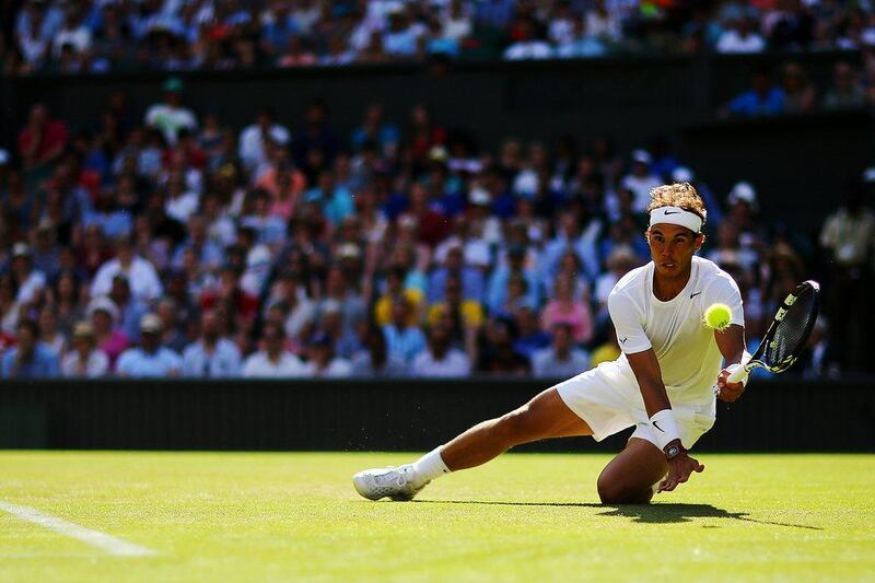 Rafael Nadal returns a shot to Martin Klizan during his first-round win at the 2014 Wimbledon Championships on Tuesday at the All England Club in London, England. Al Bello / Getty Images / June 24, 2014